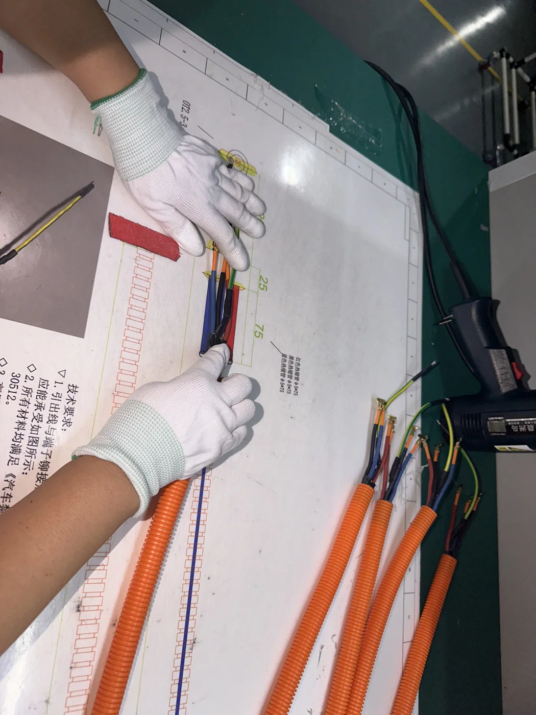 Operator following a documented harness assembly instruction
