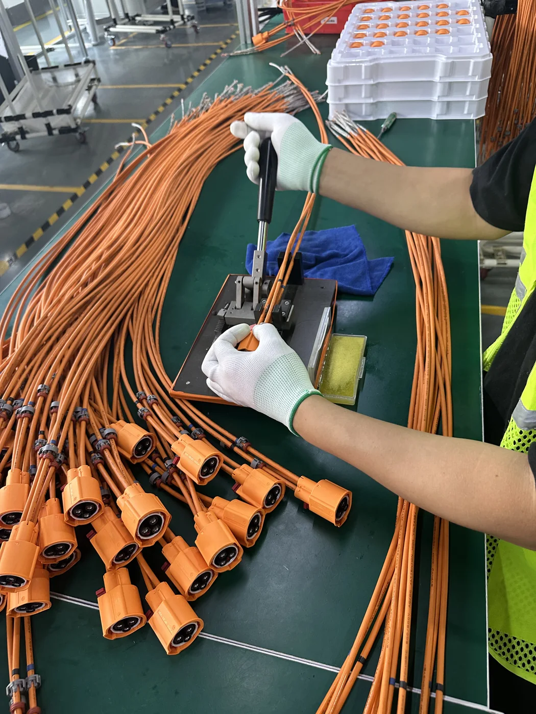 Operator assembling connectors on high-voltage cable assemblies